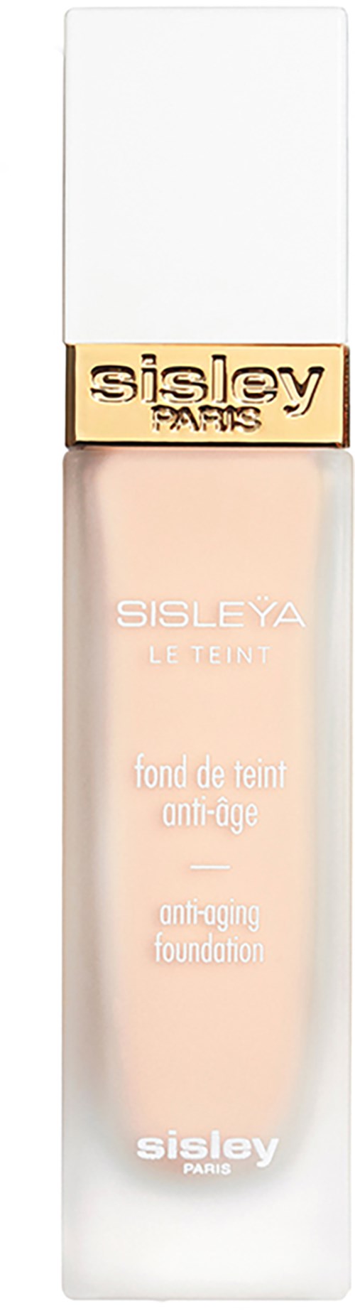 A bottle of foundation with a white cap and a gold band that says 'Sisley Paris'.
