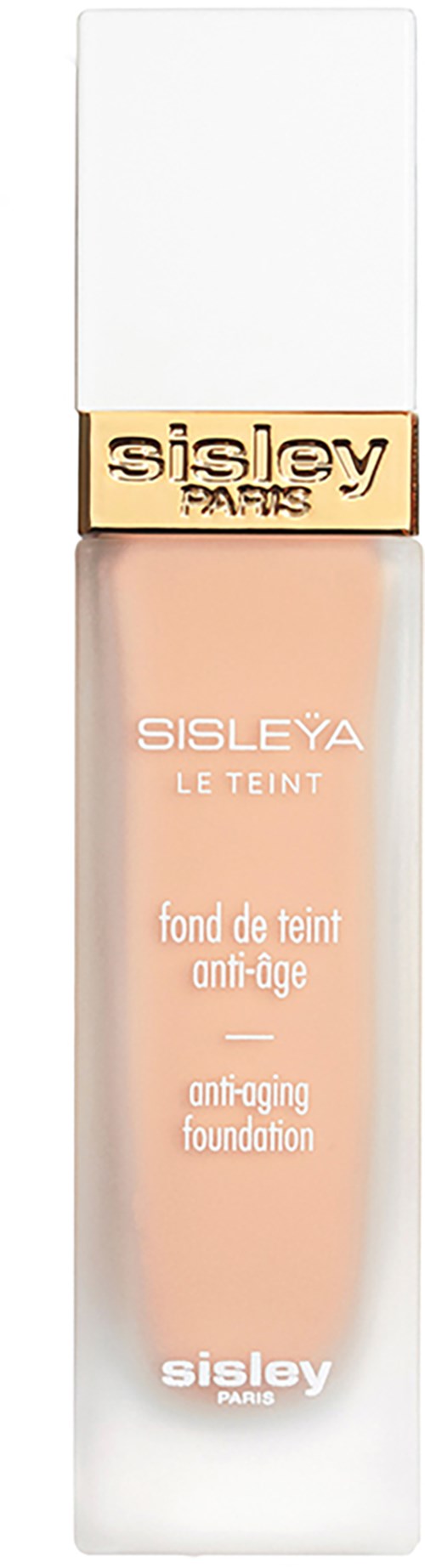 A tall, white, rectangular bottle with a white cap and a gold band labeled "Sisley Paris". The bottle contains foundation.
