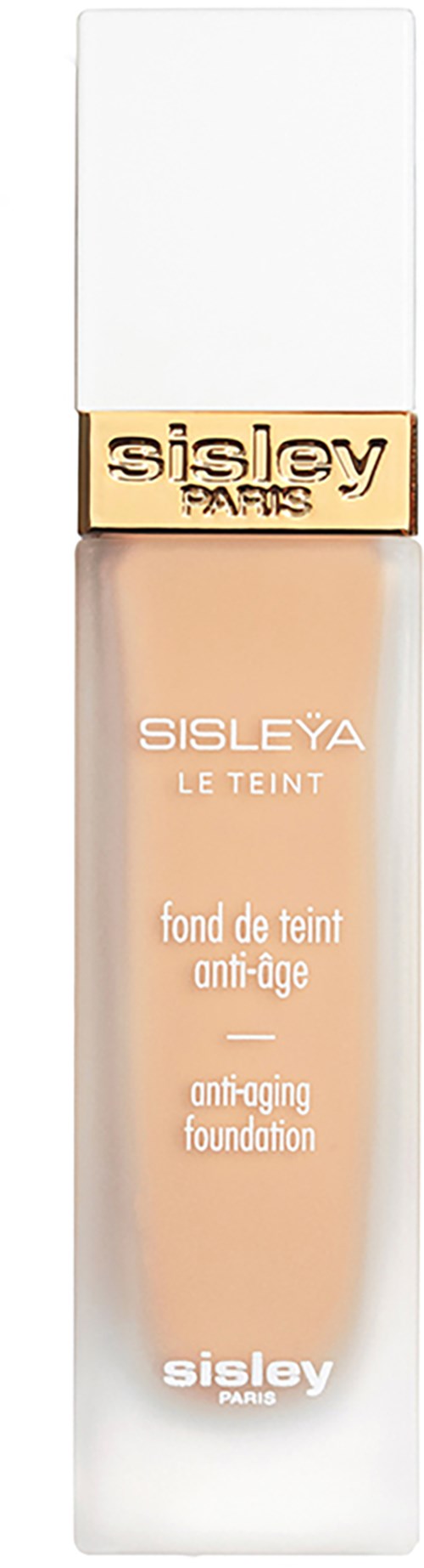 A beige foundation bottle with a white cap and gold band, labeled Sisley Paris, anti-aging.