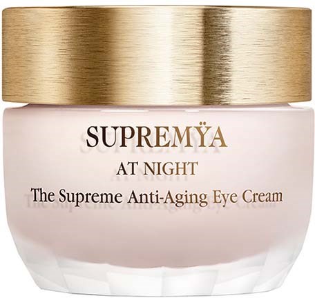 A jar of Supremeya night eye cream with a gold lid and white container. It is an anti-aging product.
