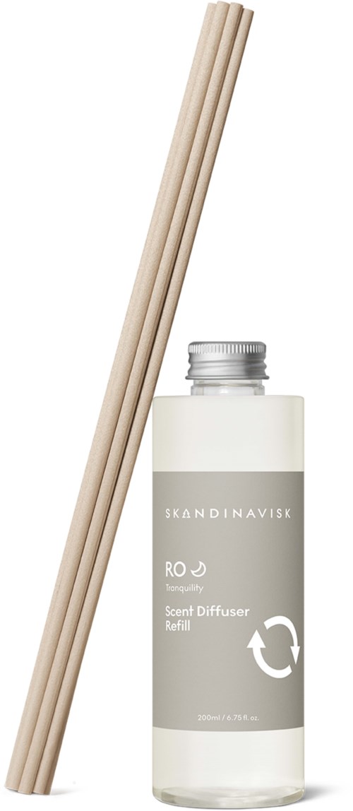 A set of three beige reed sticks and a refill bottle of scent diffuser liquid.