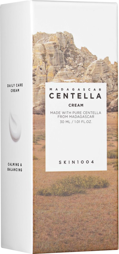 Förpackning med ökenlandskap i bakgrunden och text om Madagascar Centella-kräm för hudvård.