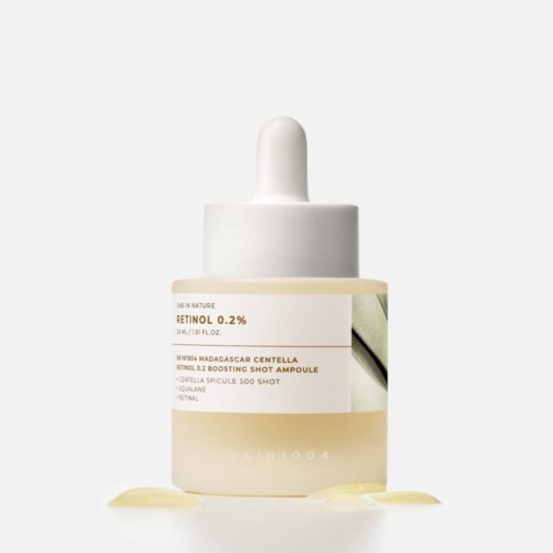 Cosmetic serum bottle with a white dropper cap and a label showing Retinol 0.2% and Madagascar Centella.