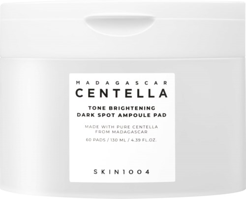 A white container with a label for Madagascar Centella tone brightening dark spot ampoule pad and product details.
