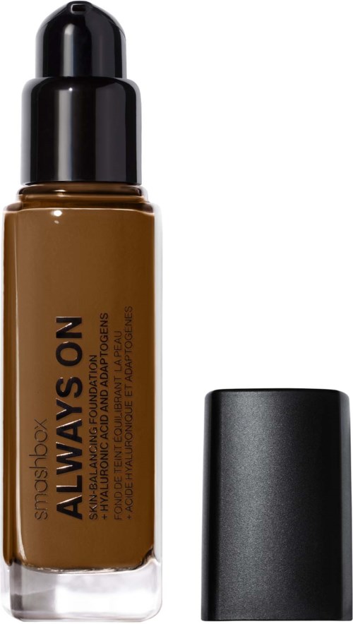 Brown liquid foundation in a clear bottle with black pump, labeled 'SMASHBOX ALWAYS ON'. Black cap beside it.