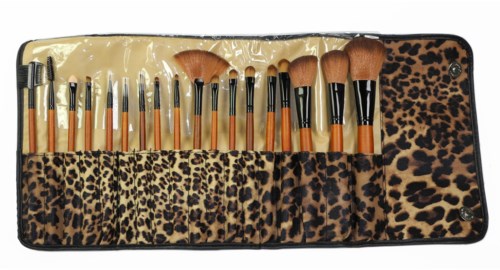 A set of makeup brushes in a leopard print case, organized from small to large with various brush types.