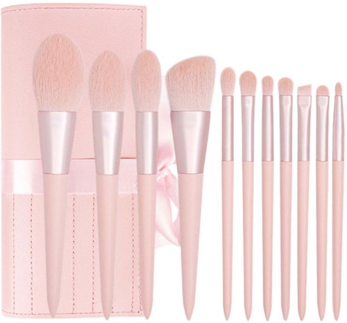 Set of pink makeup brushes with a case, varying in size and shape, used for applying cosmetics.