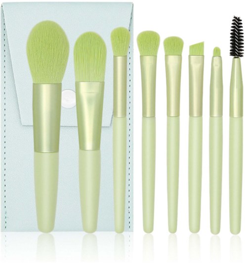 Set of makeup brushes with light-colored handles and soft, greenish bristles, includes various shapes and a mascara brush.