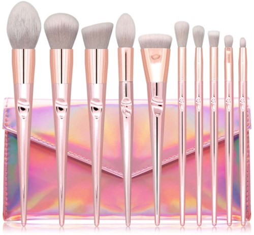 A set of ten makeup brushes with pink handles, various sizes, placed in a shiny pink box.