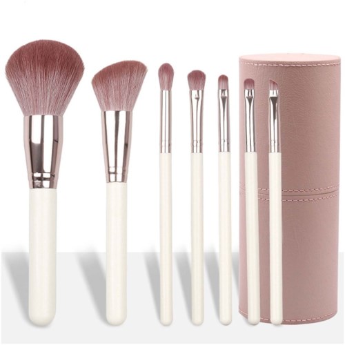 Set of makeup brushes with white handles and pink bristles, along with a pink cylindrical case.