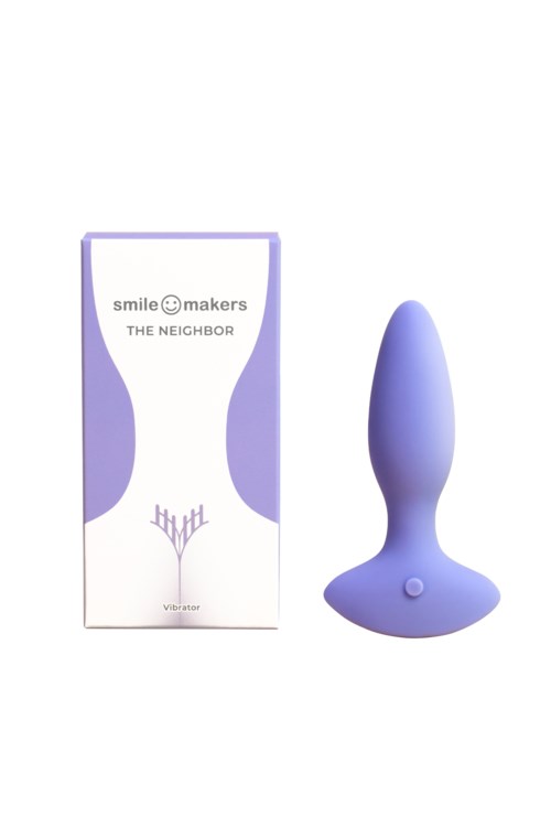 Ein lila Vibrator neben einer Schachtel mit der Aufschrift 'Smile Makers The Neighbor' im schlichten Design.