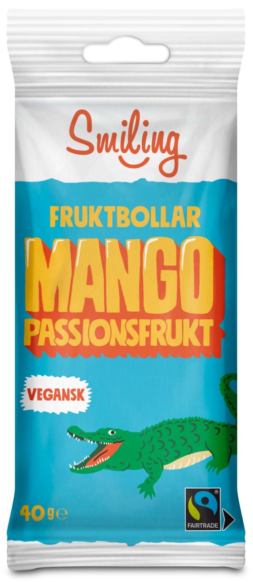 Fruit snack package with a crocodile illustration, colorful text, and labels indicating mango flavor and vegan quality.