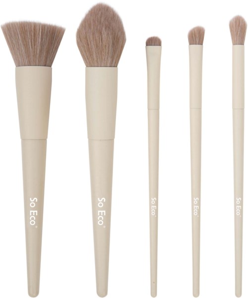 Five makeup brushes with beige handles and soft bristles, arranged in order from largest to smallest.