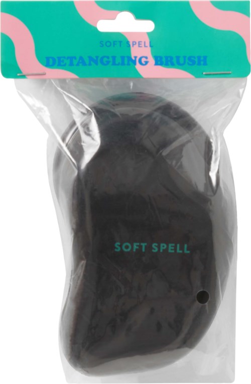 En svart børste i gjennomsiktig plastemballasje med teal og rosa etikett, merket som soft spell.