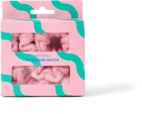 Pink packaging with teal wave patterns, featuring soft pink scrunchies labeled as 'HATLESS WAVES.'