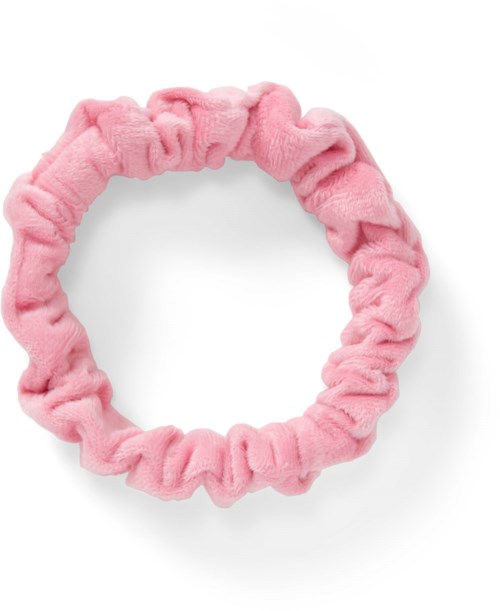 A soft pink fabric hair tie shaped in a circle with a ruffled texture.