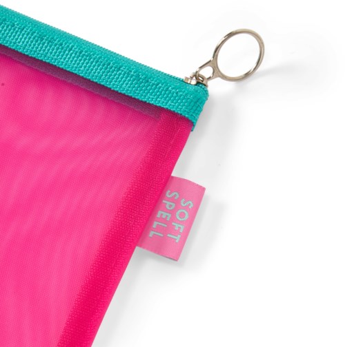 Bright pink pouch with a teal zipper and a small tag reading "SOFT SPELL."