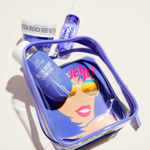 A clear bag with a woman wearing sunglasses illustration, containing skincare products like sunscreen and body butter.