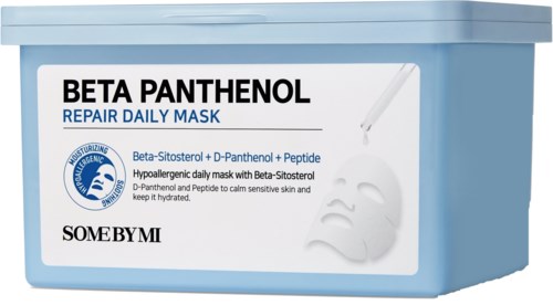 En blå behållare med en etikett för Beta Panthenol reparationsdagmask, visar en liten dropper och vitt kräm.
