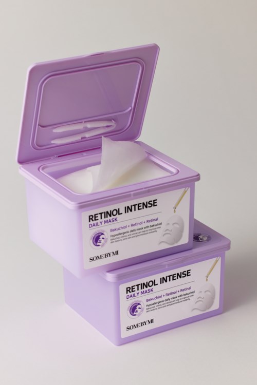 Two purple boxes of Retinol Intense daily masks, one open with tissue in it.