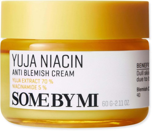 A yellow jar labeled Yuja Niacin Anti Blemish Cream with ingredients and benefits listed.