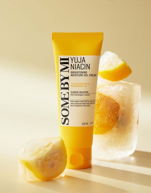 A yellow tube of skincare cream labeled 'SOMEBYMI Yuja Niacin Brightening Moisture Gel Cream' with lemon slices.