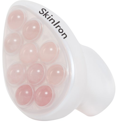En vit ansiktsapparat med flera rosa massagebollar för hudvård.