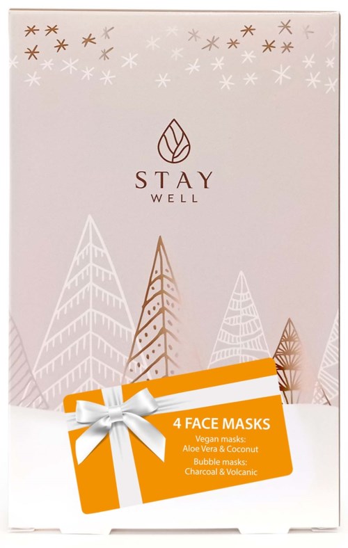 Pakkauksessa on pinkkejä ja kultaisia puita ja tähtiä, label "Stay Well" ja sisältää neljä kasvomaskea luonnollisilla ainesosilla.