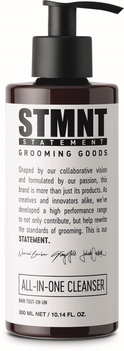 A dark brown bottle with a pump top labeled STMT, promoting grooming products and an all-in-one cleanser.