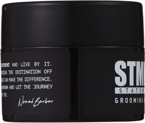A black grooming product jar with white text and signature, including the words "Statement Grooming" and motivational message.