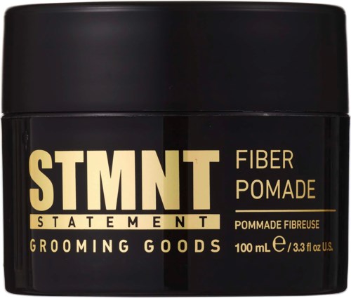 A black container with bold yellow and white text, labeled as fiber pomade for grooming goods, 100 ml.