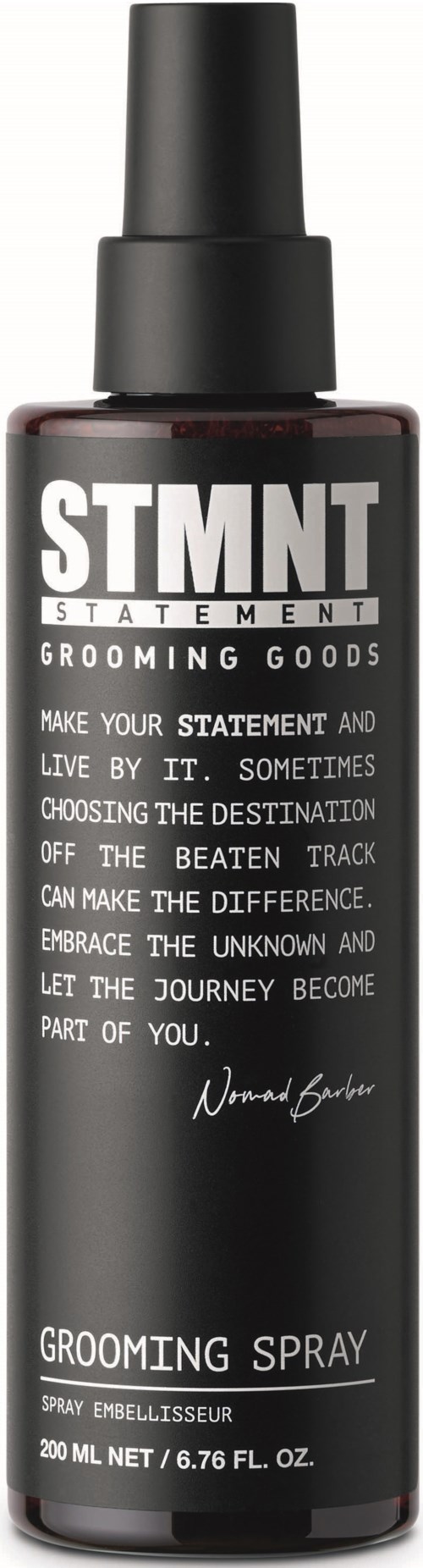 A grooming spray bottle with black and white label, name 'STMT,' and inspirational text about life and journey.