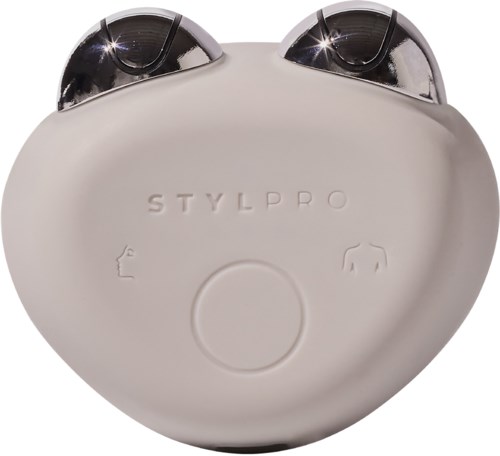 A white device labeled STYLPRO with two large black rollers on top and buttons on the front.