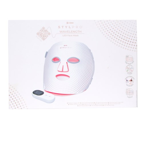 Eine weiße Gesichtsmaske mit rosa Augen, Nase und Mund, und eine Fernbedienung daneben. Es ist eine Lichttherapiemaske.