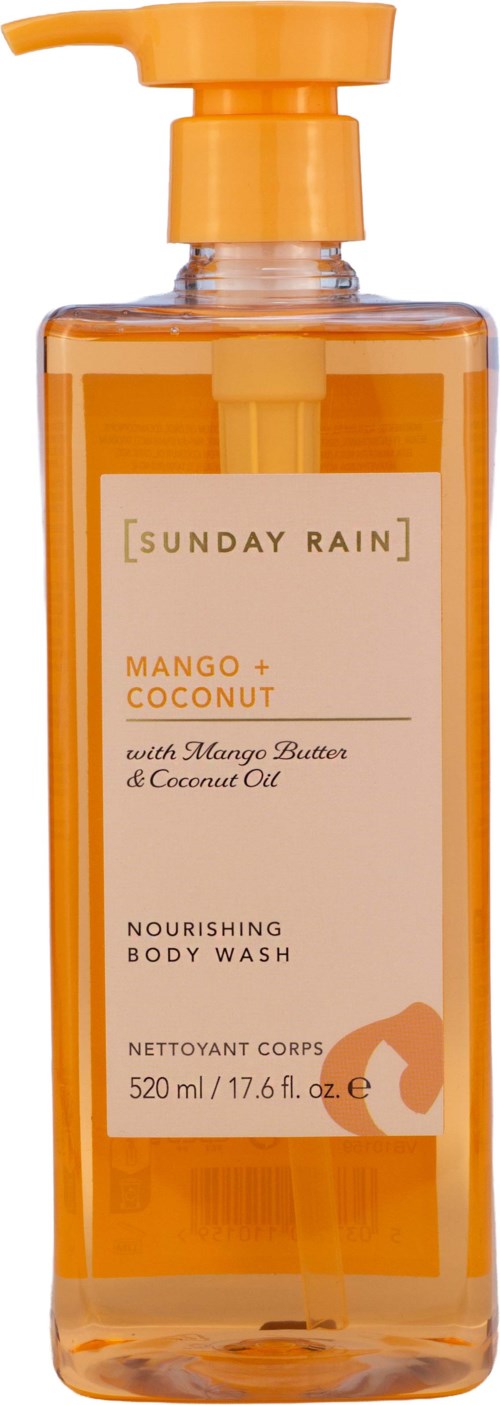 En transparent orange flaska med pump för att dosera och en etikett som anger Mango + Coconut närande body wash med doftdetaljer.