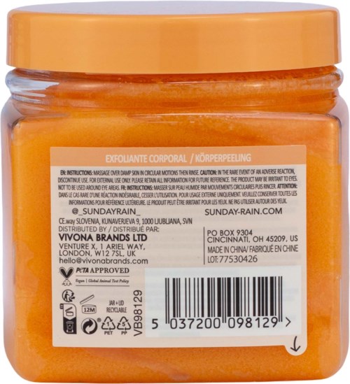 Oransje kroppsskrubb i krukke med hvit etikett som viser produktinformasjon og strekkode.