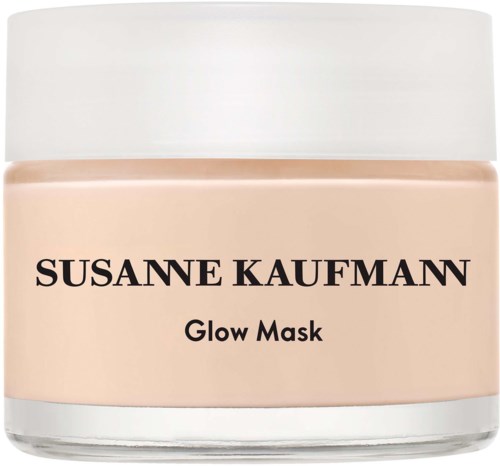 En burk märkt Susane Kaufman Glow Mask, med en beigefärgad substans inuti och ett vitt lock.