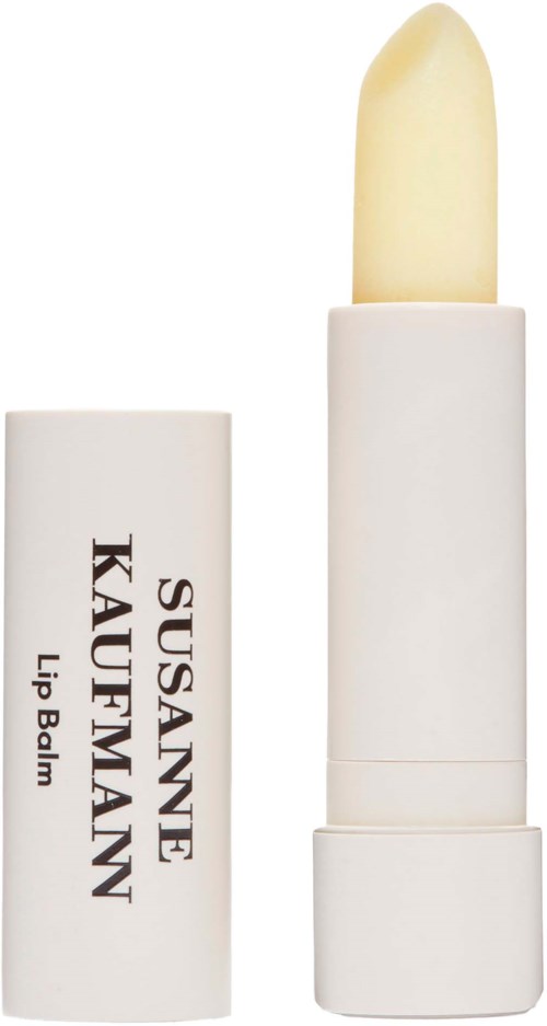 A white lipstick with a yellowish balm inside, labeled 'Susanne KAUFMANN Lip Balm'.