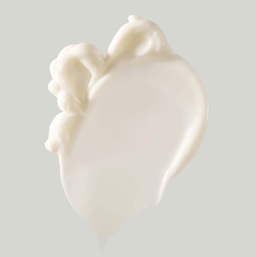A white heart-shaped object with decorative floral designs on the upper left side.