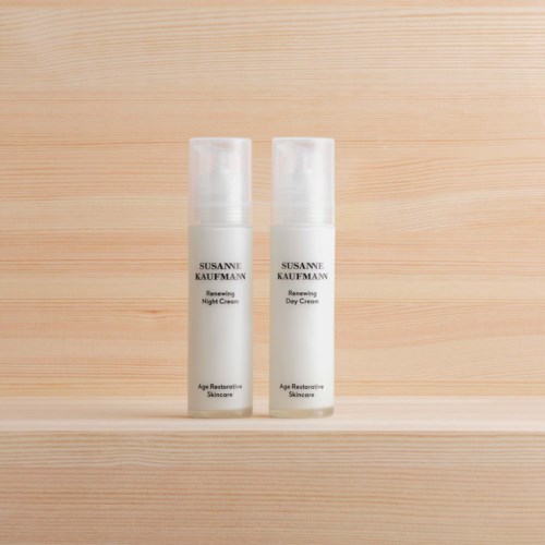 Two skincare bottles labeled for night and day use, placed on a wooden surface. Simple and clean design.