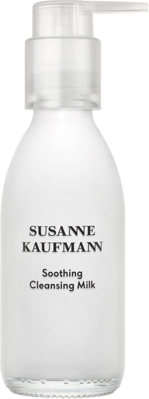 A white bottle with a pump, labeled Susanne Kaufmann Soothing Cleansing Milk.