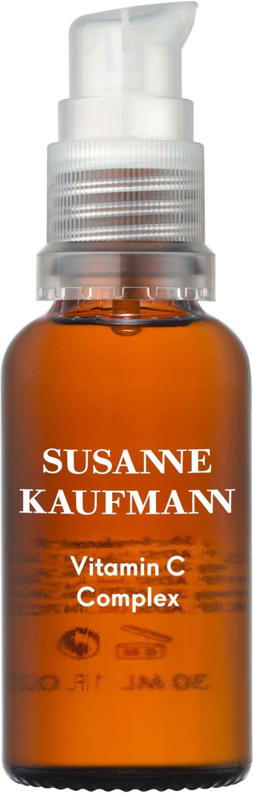 Gyllene glasflaska med vit pump märkt "Susanne Kaufmann" och "Vitamin C Complex".