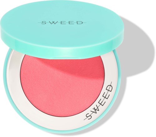 A round container with a light blue lid holding pink blush inside. The lid and blush have the brand name "SWEED".