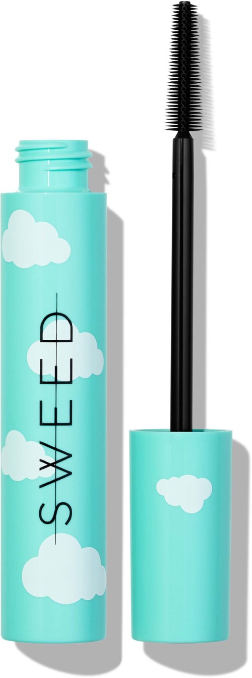 A blue mascara tube with white clouds, with the cap removed showing the mascara wand.