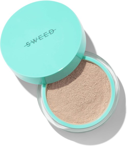 A round container with a light blue lid labeled "SWEED" holds beige powder inside.