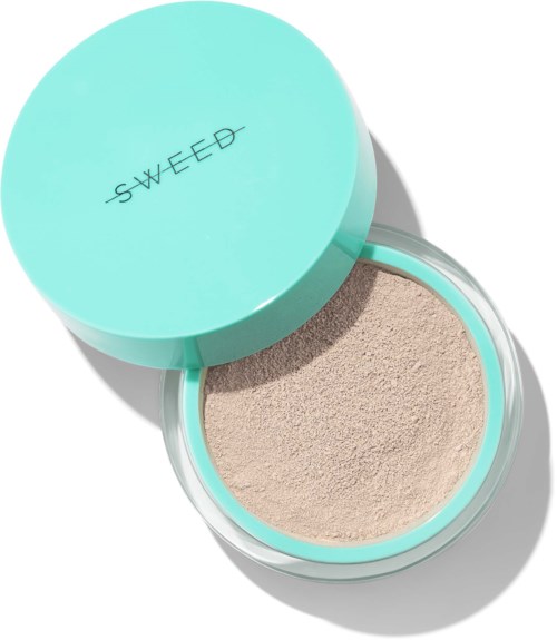 A round container with a lid labeled "SWEED", filled with beige loose powder, light blue packaging.
