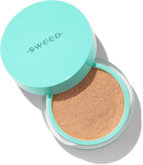 A round, light blue container with the word "SWEED" on the lid, containing brown powder inside.