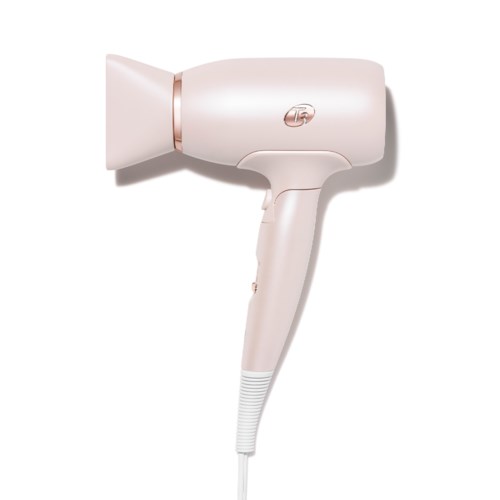 A light pink hairdryer with a handle, nozzle, and cord, standing alone against a white background.