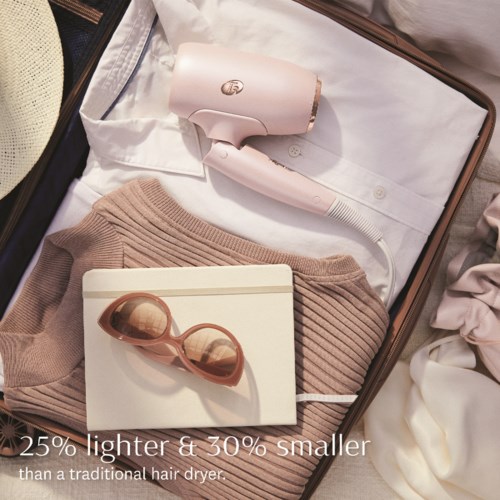 A suitcase contains a hairdryer, sunglasses, a sweater, and clothes. Text says it's smaller and lighter than a traditional hairdryer.