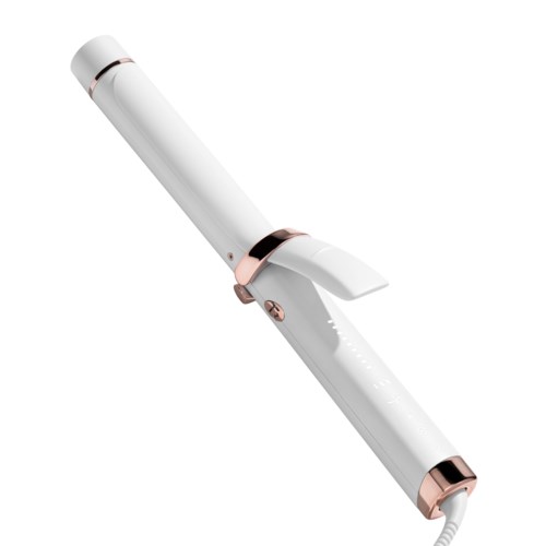 A white curling iron with rose gold accents, featuring a handle, clamp, and a long barrel for styling hair.